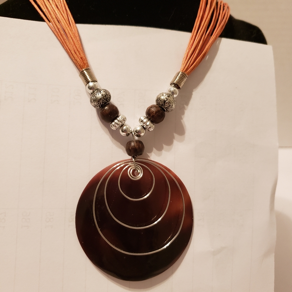 Necklace, amber color with silver accents.